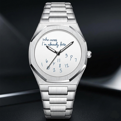 Silver watch with a unique text design on the dial against a dark background